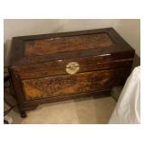 Carved Asian trunk with blankets