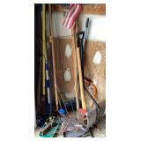 Long handled tools and items in corner of garage