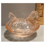Pink glass hen on a nest