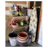 Gardening and ironing board in garage corner