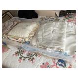 Lot of quilts and pillows with storage tote