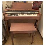 Estey organ, bench, and music