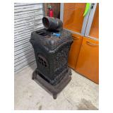 Cast Iron Parlor Stove No. 403B with Ornate Scrollwork and Vent Pipe