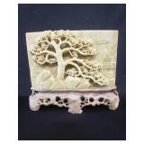 Asian carved stone plaque on stone base