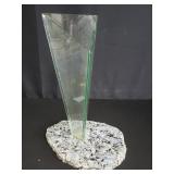 Triangular glass vase on a stone base