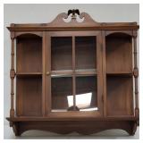 Contemporary wall cabinet with brass eagle finial