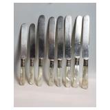 Eight butter knives with sterling silver bands