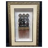 Shadowbox display of carved wooden African