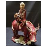 Chinese porcelain man riding an ox figurine