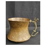 Antique hammered copper mug with decorative b
