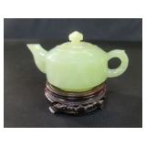 Vintage Asian jadeite teapot on a wood stand