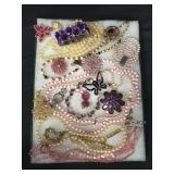 Riker display case of costume jewelry,