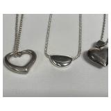 Group of sterling silver necklaces with pendants