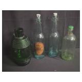 Four antique glass bottles
