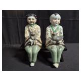 Asian porcelain figurines on bench