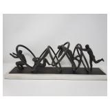 Iron Jumping through hoops sculpture