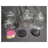 Group of glass domes with wood stands