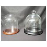 Pair of glass domes with stands