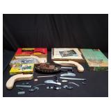 Group of model guns, ships, and cars