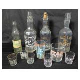 Vintage liquor bottles and shot glasses.