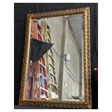 Ornate gilt wood framed wall mirror