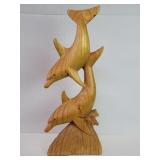 Carved wood dolphins sculpture