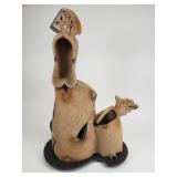 Signed Kaminer ceramic sculpture on a iron base.