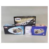 Three 1:24 scale die-cast car models