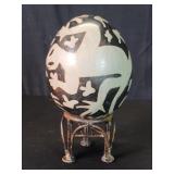 Vintage hand painted gecko pottery egg on a