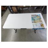 Adjustable height folding table
