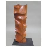 Signed abstract style carved wood sculpture on a