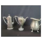 Three silver plate pitchers