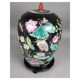 Asian porcelain ginger jar on a wood stand