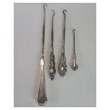 Four sterling silver handled buttons hooks