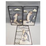 Three metal penguin wall plaques