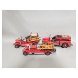 Three vintage metal fire trucks