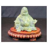 Vintage stone Buddha sculpture on a wood base