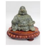 Vintage stone Buddha sculpture on a wood base