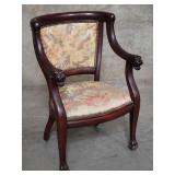 Antique mahogany arm chair on casters with lion