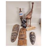 African carved masks, giraffe, and a carved
