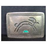 Silver Navajo belt buckle with an engraved animal