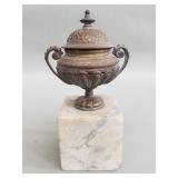 Antique bronze urn on a marble base