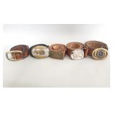 Group of leather belts with brass and silver plate