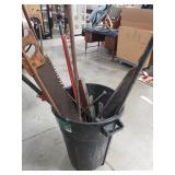 32 gallon bin with miscellaneous tools , saw,