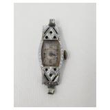 Art Deco 18k white gold watch with green stones
