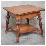 Antique oak parlor table on casters