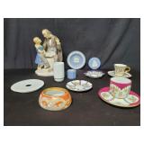Group of porcelain teacups, saucers, figure
