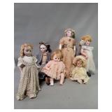 Group of vintage porcelain and fabric dolls
