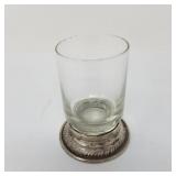 Antique whiskey tumbler sitting in a gadrooned