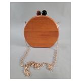 Round wood clutch with contrasting brown and